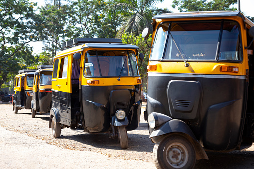 This image features a Goan Tuk Tuk, one of the most iconic modes of transport in India. Coloured in bright yellow and black and often adorned with various decorations, these three-wheeled vehicles are a staple in Goa's busy streets. Known for their agility and ability to navigate through narrow lanes, Tuk Tuks are an efficient and culturally immersive way to get around. The photograph captures the distinctive design and vibrant colours of the vehicle, offering viewers a slice of everyday life in Goa. Whether used by locals or tourists, the Tuk Tuk remains an enduring symbol of Goan transport and culture.