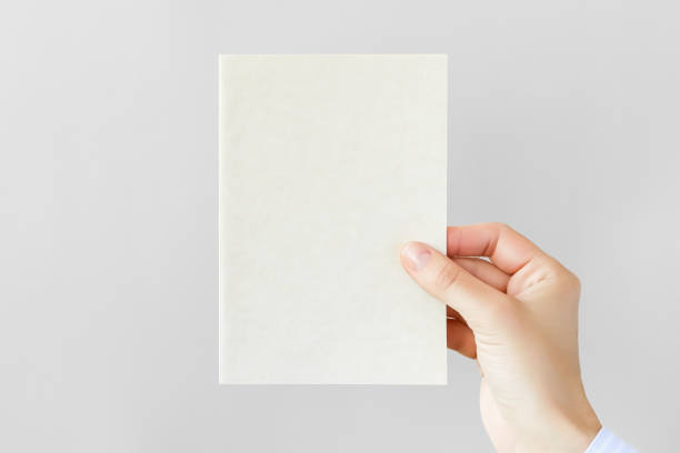istock female hand holding a blank postcard on a gray background 1743199298