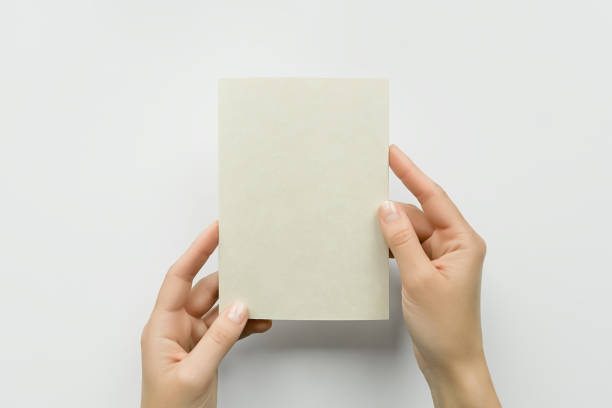 istock female hands holding a blank postcard on a gray background 1743199311