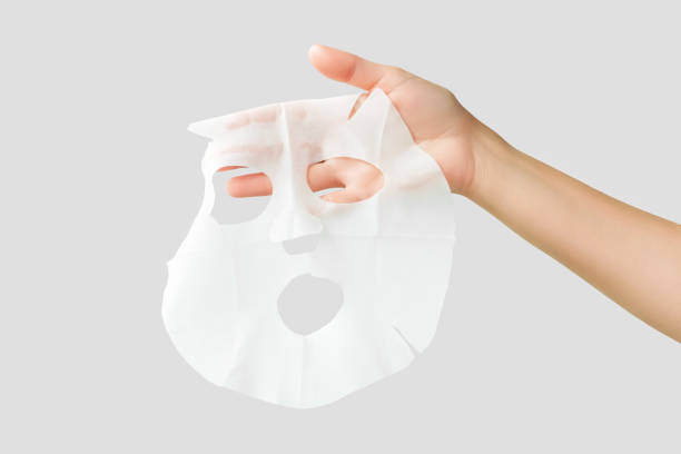 istock hand holding moisturising face mask isolated on gray background 1743208640