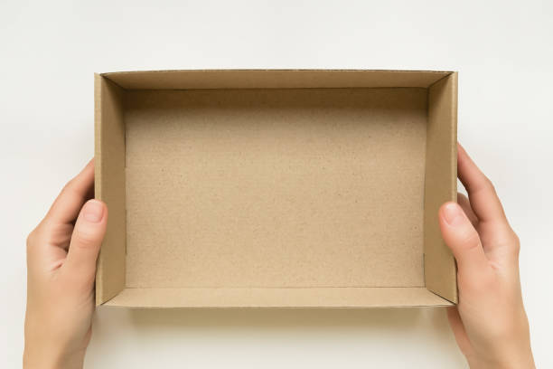 istock female hands holding an open cardboard box on a white background. packaging and delivery concept, top view 1743214781