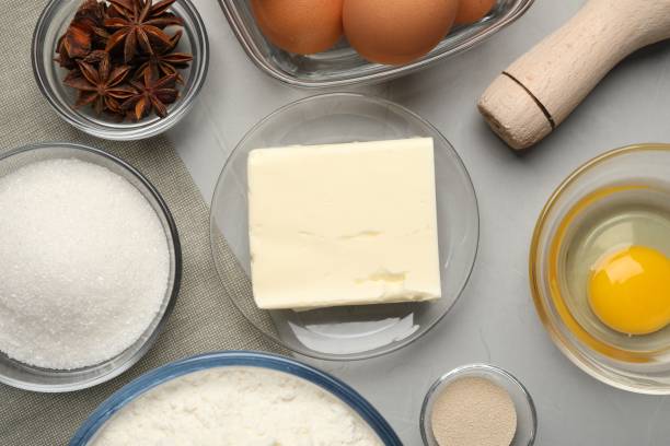 istock Flat lay composition with flour, butter and different ingredients on light grey table. Yeast pastry 1743247151