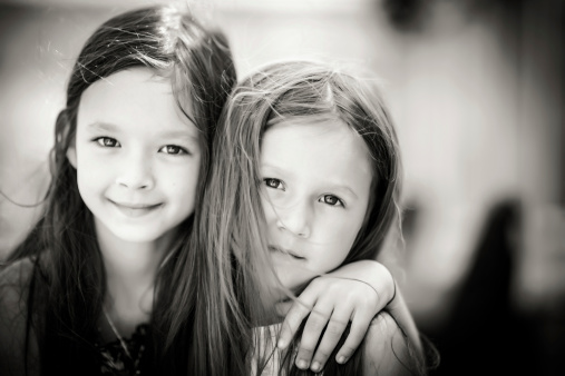 Little cute sisters. Bw portrait.