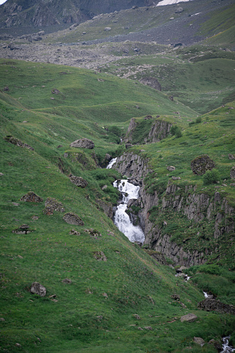 A view of stream of water flowing down Juta Canyon from the snow mountains