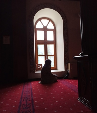 A woman prays in a mosque