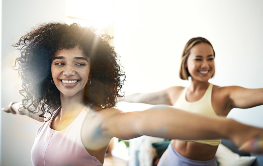 Women, fitness friends with stretching and yoga, happy at home with bonding and training together. Pilates, wellness and lens flare with exercise or workout, yogi team smile with self care and body