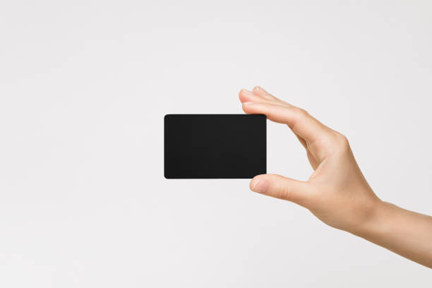 istock female hand holds a black plastic card on a gray background 1743285046