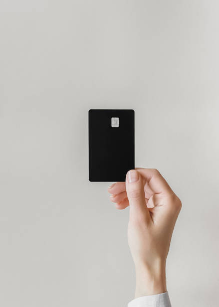 istock female hand holds a black plastic Visa card on a gray background 1743286108