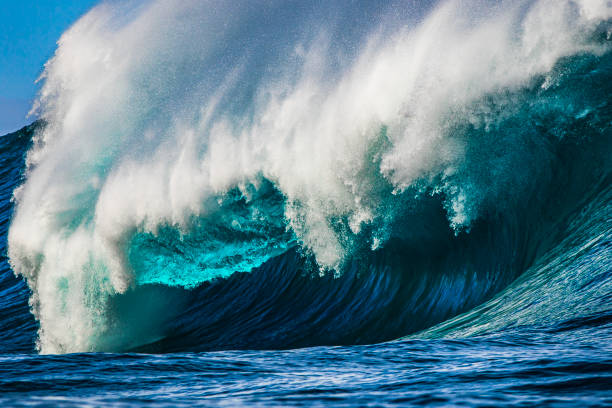 istock Big blue wave breaking in the open ocean over a shallow reef bombora 1743287677