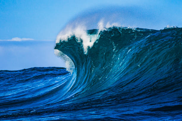 istock Big blue curved wave breaking in the open ocean over a shallow reef bombora 1743287686