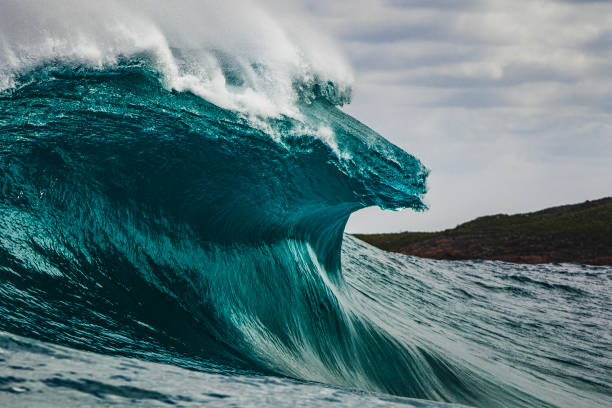 istock Big blue curved wave breaking in the open ocean over a shallow reef bombora 1743288729