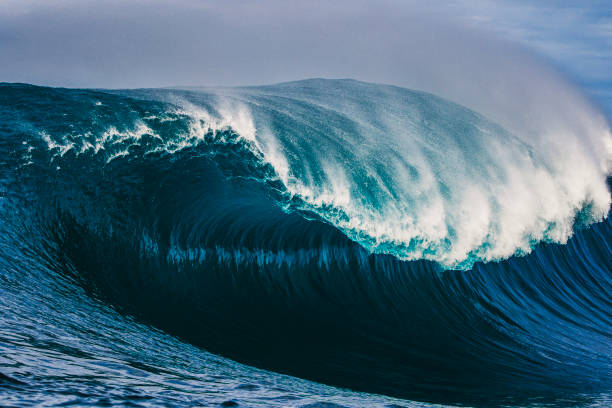 istock Big blue curved wave breaking in the open ocean over a shallow reef bombora 1743289808