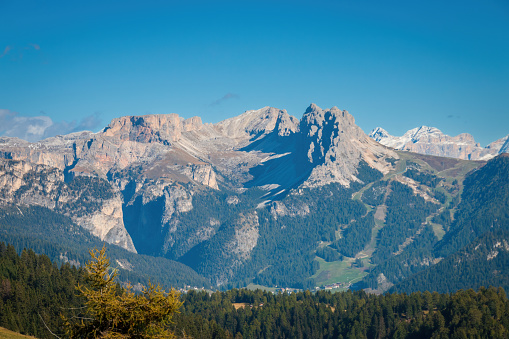 Scenic view of Pizes de Cir mountain group (right) seen from Seiser Alm Alpe di Siusi, Dolomites, South Tyrol, Italy in autumn against blue sky