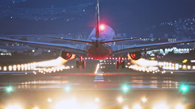 Large commercial airplane landing on runway, passenger landed safely at night. Journey abroad tourism, oversea travel, flight transit, air travel transport, airline business, transportation industry