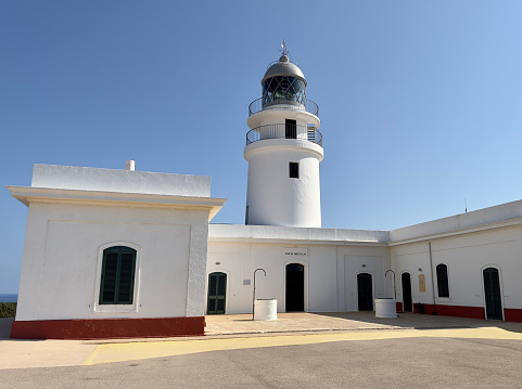 The historic Cavalleria lighthouse built in 1857 on the northern coast of the island of Minorca in the Balearics.