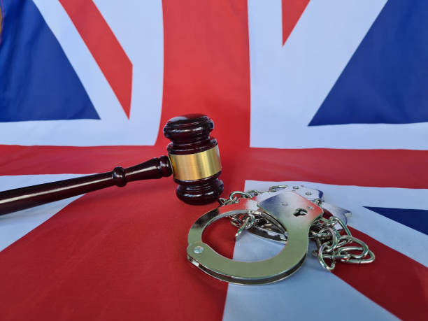istock Great Britain flag with judge gavel and handcuffs 1743321076