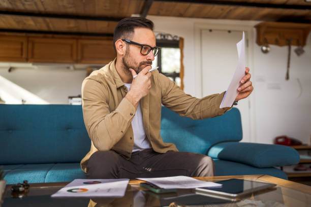 istock Man mature caucasian male work at home hold contract document 1743325349