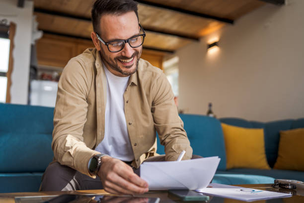 istock Man mature caucasian male work at home hold contract document smile 1743325376