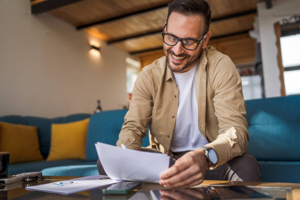 istock Man mature caucasian male work at home hold contract document smile 1743326509
