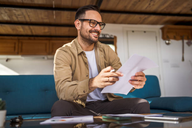 istock Man mature caucasian male work at home hold contract document smile 1743326549