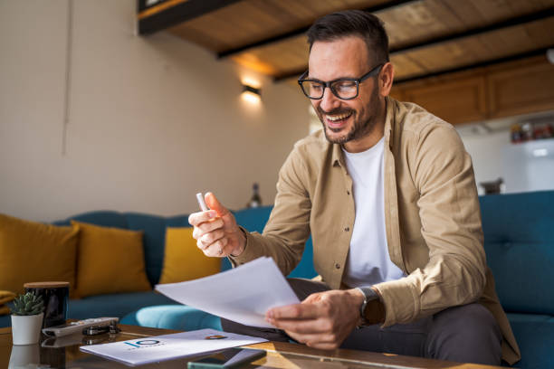 istock Man mature caucasian male work at home hold contract document smile 1743326558