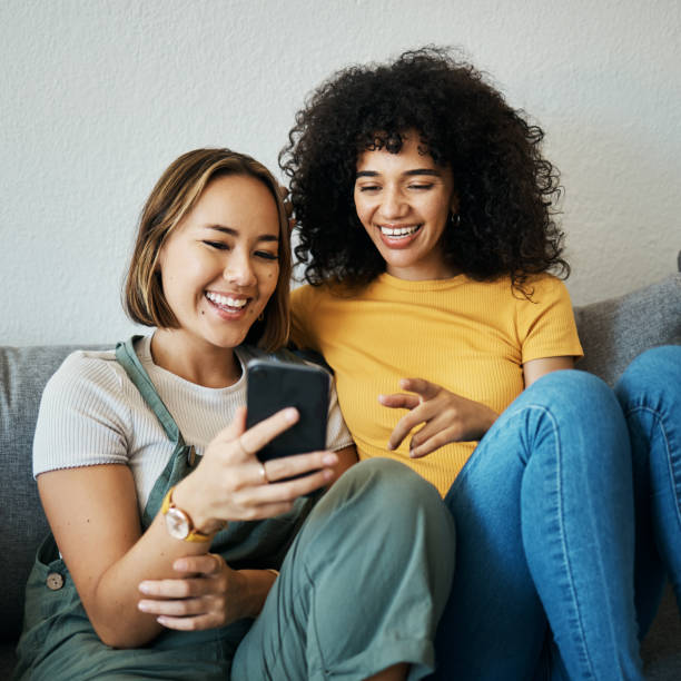 istock Friends, relax on sofa with smartphone and chat online with communication, funny meme and reading text message. Women with technology, mobile app and  typing on social media with connectivity at home 1743336700