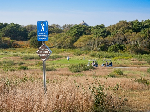 Nobody but golfers, a sign at Cape Cod national seashore warns tourists to not venture on to adjoining golf course.