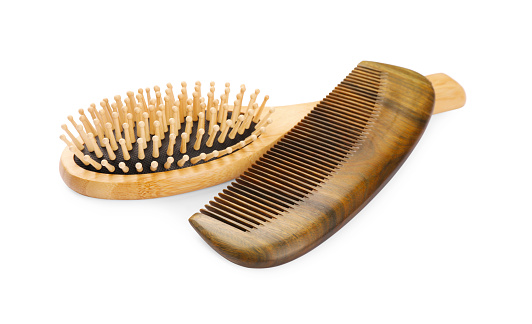 New wooden hair brush and comb isolated on white