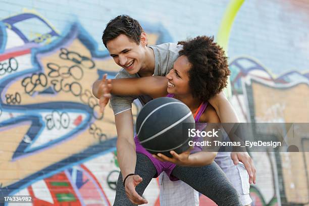 Woman Playing A Game Of Basketball Against Man Stock Photo - Download Image Now - 20-24 Years, Active Lifestyle, Adult