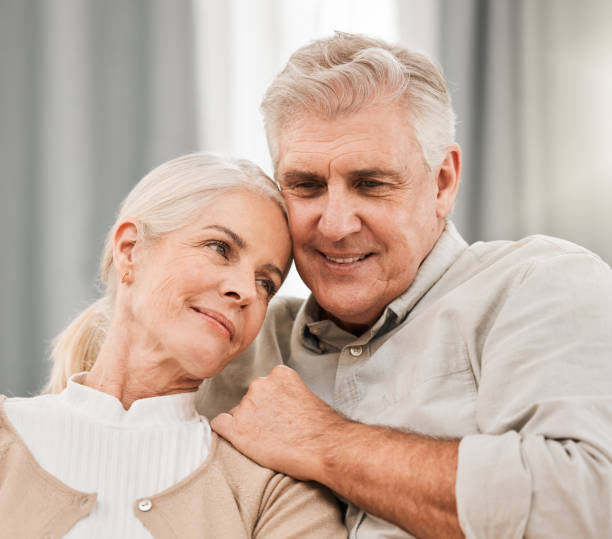 istock Old couple, hug and relax on sofa with love and support, bonding while at home with trust and comfort. People with time together, marriage or life partner with retirement, calm and peace of mind 1743350977