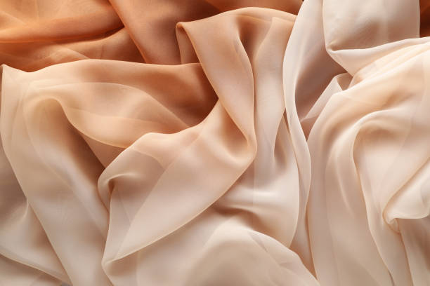 istock Beautiful beige tulle fabric as background, top view 1743351559