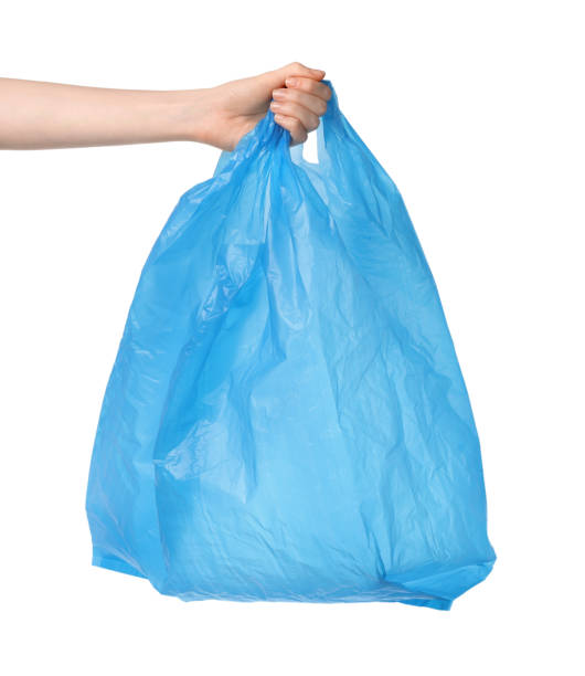 istock Woman holding light blue plastic bag on white background, closeup 1743354177