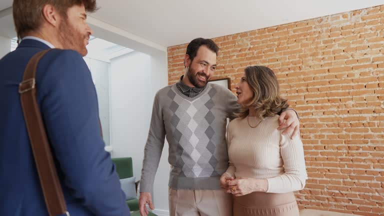 Couple visiting house with real estate agent