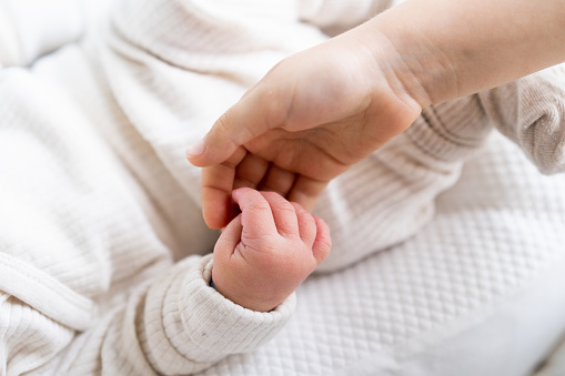 children's hands, the meeting of a newborn and an older child, the concept of the relationship between children in the family, brother and sister.