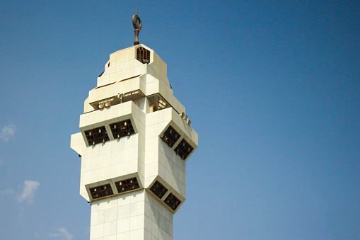 Mosque minaret with blue sky background. With copy space.