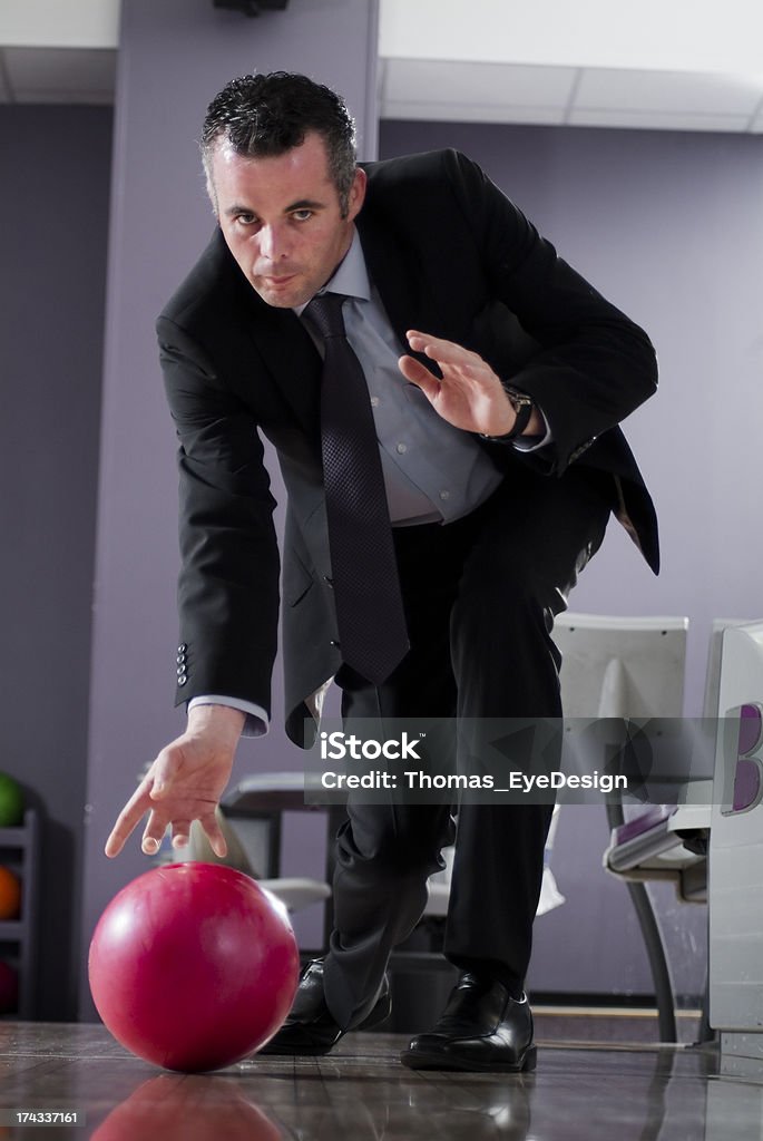 Businessman Bowling Series Bowling businessman, taking aim and getting ready to bowl the winning frame. Part of a series of business concept images. Ten Pin Bowling Stock Photo