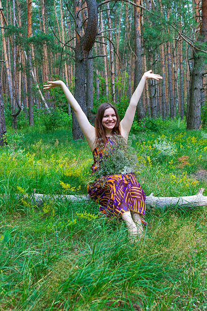istock Pretty woman with flowers and raised hands 174337832
