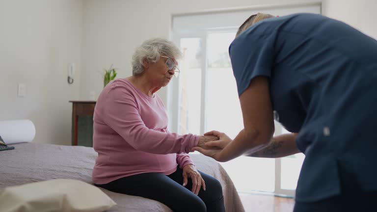 Nurse talking to a senior woman at home