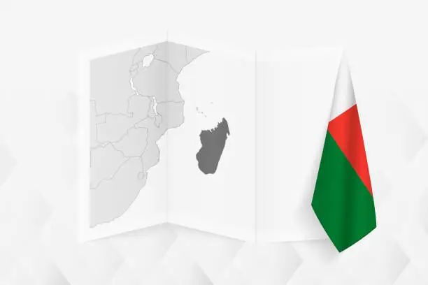 Vector illustration of A grayscale map of Madagascar with a hanging Madagascan flag on one side. Vector map for many types of news.
