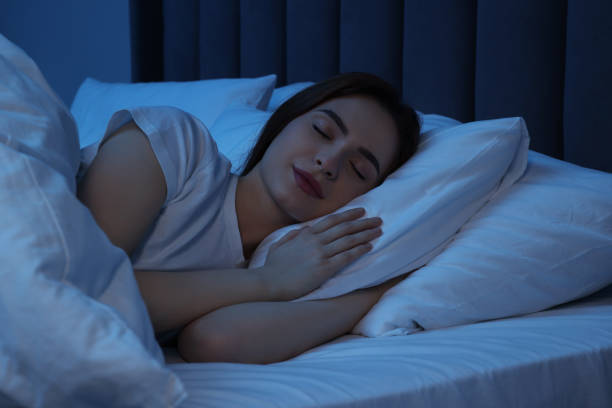 istock Beautiful young woman sleeping in bed at night 1743430374