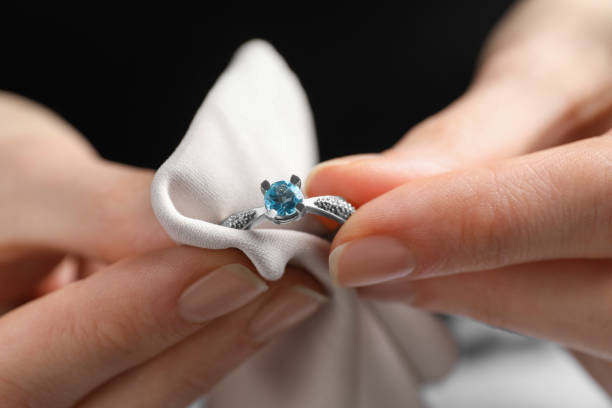istock Jeweler cleaning topaz ring with microfiber cloth, closeup 1743461446