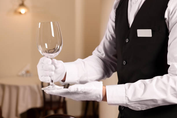 istock Man setting table in restaurant, closeup. Professional butler courses 1743495507