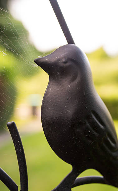 istock Wrought Iron Sculpture of Bird with Spider Web 174350973