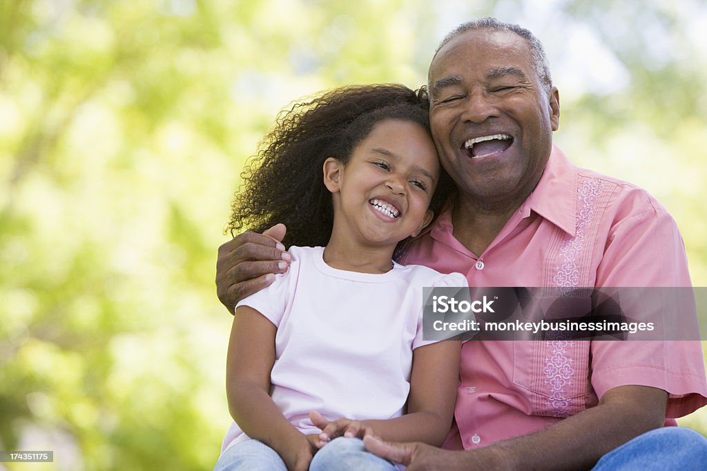 Grandfather and granddaughter outdoor portrait Grandfather and granddaughter outdoors smiling and laughing Grandfather Stock Photo