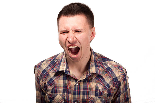 istock Man in a plaid shirt shouts 174355984