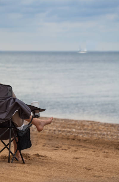 istock barefoot in beach chair 174356278