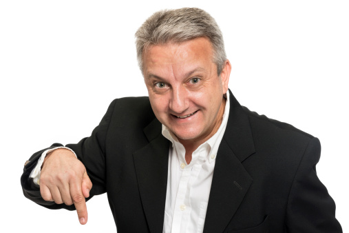 Mature man posing pointing down on white background