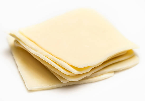 Monterey jack cheese Slices of monterey jack cheese on white background American Cheese stock pictures, royalty-free photos & images