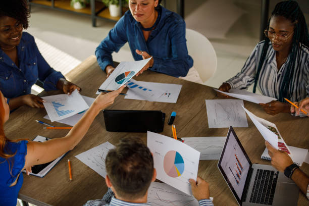 istock Group of business people sharing and analyzing documents during a meeting 1743578969