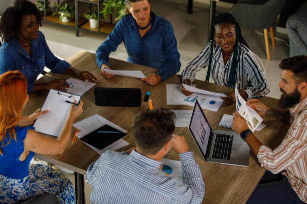 istock Group of business people sharing and analyzing documents during a meeting 1743578986